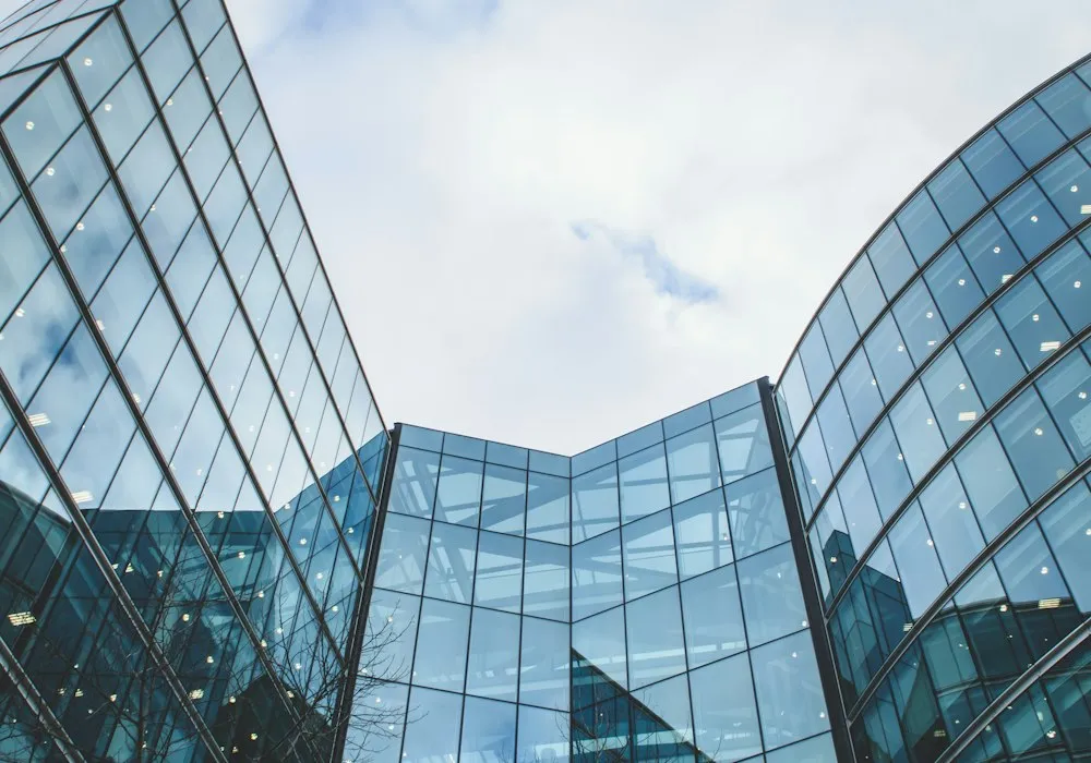 Glass office towers seen from below.